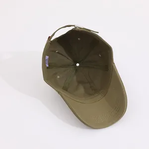 Detail view of cotton baseball cap interior with 6-panel stitching and metal buckle