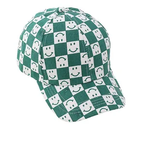 Kids baseball cap featuring green and white checkered pattern with smiley face designs