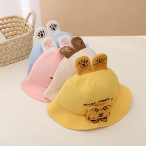 Close-up of baby sun hats in yellow, beige, pink and blue with cute animal ears