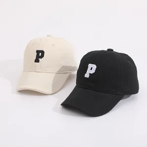 Close-up of kids candy-colored baseball caps with 3D letter P embroidery details