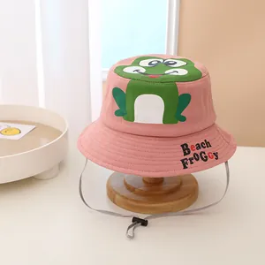 Detailed view of pink cotton sun hat with cartoon frog embroidery and windproof strap