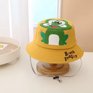 Detail of yellow cotton kids bucket hat with green frog print and adjustable drawstring