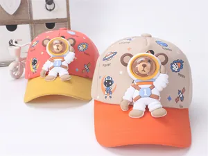 Detail of children's baseball caps with 3D astronaut bear and space theme prints