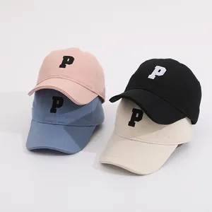 Set of four candy-colored kids' baseball caps with P letter embroidery in pink and blue