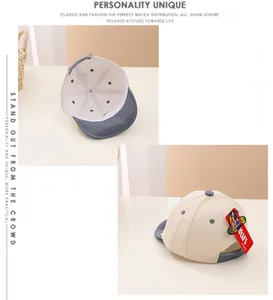 Detail of baby baseball cap featuring R letter embroidery and inner support structure