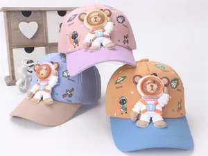 Detailed view of kids space-themed baseball caps with 3D astronaut bear and cute planet prints