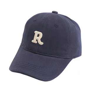 Navy blue cotton baseball cap for kids with white embroidered letter R and curved brim