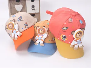 Detail of children's baseball caps with 3D astronaut bears and space theme prints
