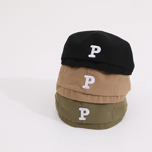 Details von Kinder-Baskenmützen in Schwarz Khaki und Grün mit besticktem P-Buchstaben