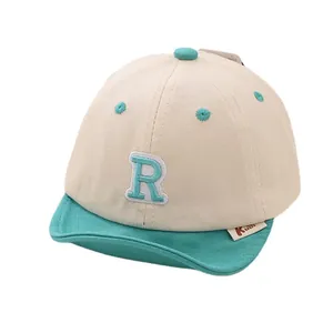 Two-tone infant baseball cap with soft brim and embroidered letter R on front