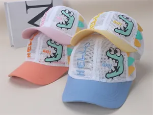 Detailed view of breathable mesh kids' baseball caps with colorful cartoon dinosaur embroidery
