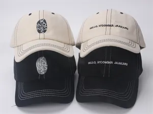 Detailed view of kids' cotton baseball caps featuring kindness embroidery and fine stitching