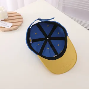 Internal details of kids baseball cap showing reinforced stitching and adjustable strap