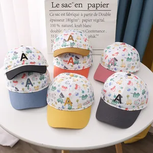 Close-up of children baseball caps set with colorful car prints and embroidered A letter