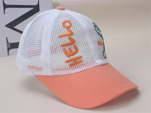 Detail of pink mesh kids sun hat with cartoon dinosaur patch and Hello embroidery
