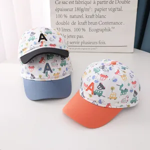 Detail of kids baseball caps featuring colorful car prints and 3D embroidered letter A