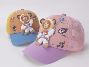 Close-up of children's summer mesh baseball caps with 3D cartoon astronaut bear design