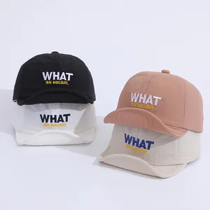 Detail view of quick-dry baseball caps in four colors with WHAT ON HOLIDAY embroidery