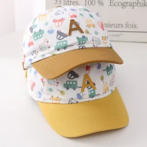 Close-up of children's cotton baseball caps with colorful car prints and 'A' patch