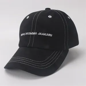 Close-up of black cotton baseball cap featuring white contrast stitching and embroidery