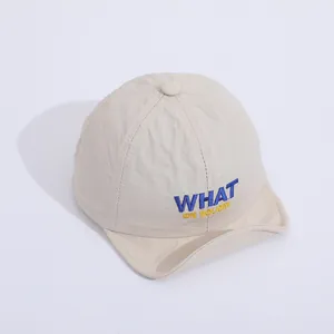 Detailed close-up of WHAT embroidery on the breathable baby soft brim baseball cap
