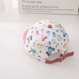 Detail view of pink bill toddler baseball cap with colorful cartoon cars and metal buckle