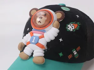 Close-up of 3D astronaut bear on kids baseball cap with space motifs and mesh side