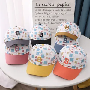 Detail of colorful kids baseball caps with smile print and embroidered B letter