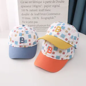 Three kids' cotton baseball caps with colorful 'B' letter patches and smiling patterns