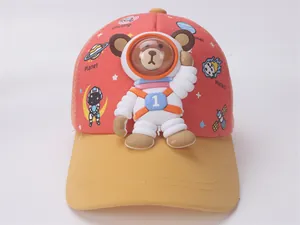 Detail of toddler baseball cap with 3D astronaut bear and yellow brim in vibrant red