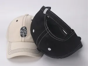 Detail view of cotton kids baseball caps with kindness embroidery and contrast stitching