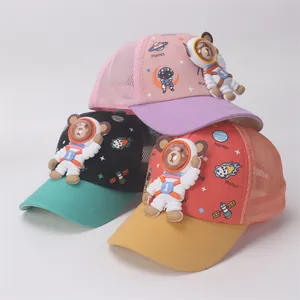 Close-up of kids mesh trucker hats with 3D astronaut bear and space planet prints
