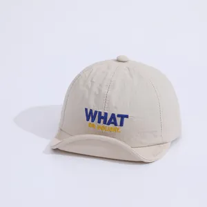 Detailed view of the soft white fabric and colorful letter embroidery on this baby sun cap
