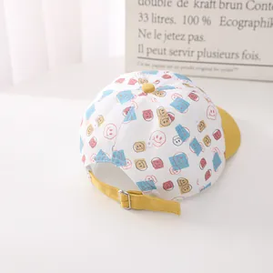 Detail view of cotton baseball cap with colorful smiley faces and adjustable yellow strap