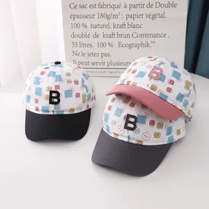 Detailed view of three cotton baseball caps with smiley prints and 3D letter B patches