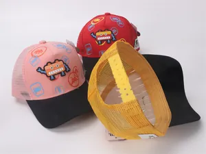 Detail view of kids trucker hats with pixel robot patches and mesh back in various colors