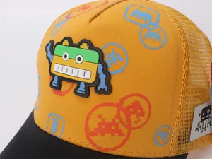 Detail of children's baseball cap featuring a 3D robot badge and breathable mesh back