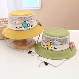Detail of yellow cotton kids bucket hat with breathable mesh and dinosaur embroidery