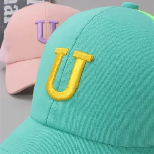 Close-up of summer mesh baseball caps with 3D letter U embroidery and breathable panels