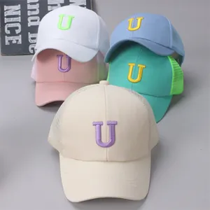Detailed close-up of breathable mesh panels and bold U embroidery on kid's baseball caps
