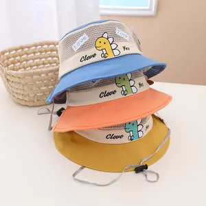 Detail of dinosaur embroidery and mesh vents on colorful kids sun protection bucket hats