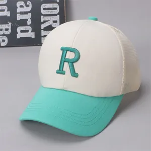 Close-up of R embroidery and breathable mesh on mint green kids baseball cap