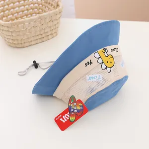Detail of blue kids sun hat with breathable mesh, dinosaur embroidery and safety chin strap