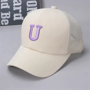Detail of mesh back panels and premium purple letter U embroidery on the baseball cap