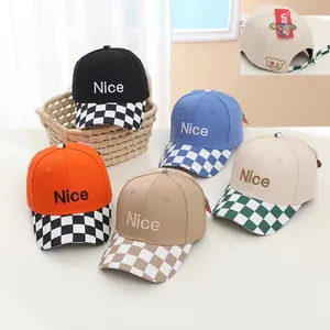 Detail of adjustable strap and bear embroidery on checkered visor baseball caps