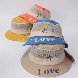 Detail of mesh sun hats for kids featuring LOVE embroidery in multiple vibrant colors