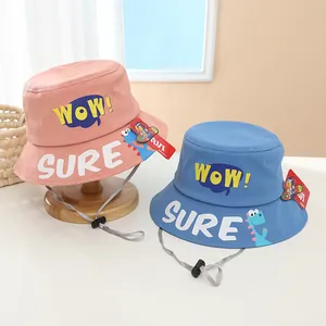 Detail of pink and blue kids bucket hats with WOW! text and dinosaur graphics
