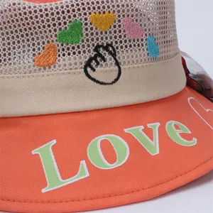 Detailed embroidery of colorful hearts and Love text on child's sun hat mesh