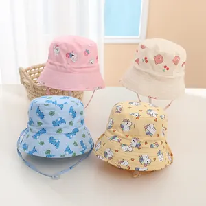 Detail of four colorful kids bucket hats with cartoon prints and adjustable chin straps