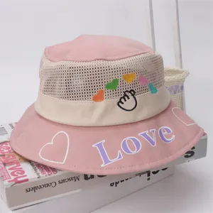 Close-up of pink mesh sun hat for kids featuring LOVE embroidery and heart patterns